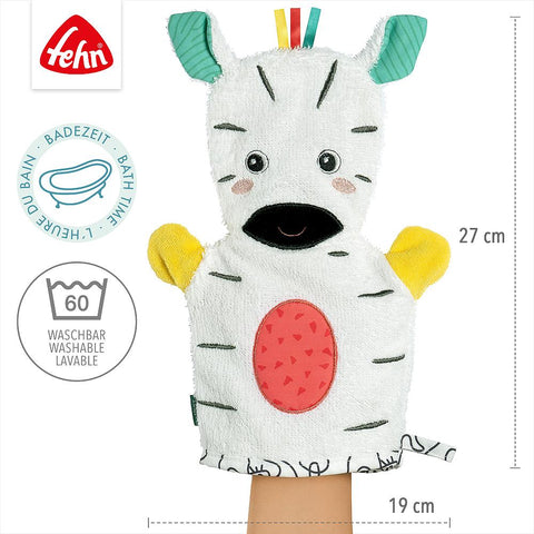 Der Waschhandschuh Zebra ist eine weiche Handpuppe in Form eines Zebras, mit bunten Ohren und Armen, hergestellt aus Handtuchfrottee. Er misst 27 x 19 cm, ist abwaschbar und perfekt für den Badespaß.