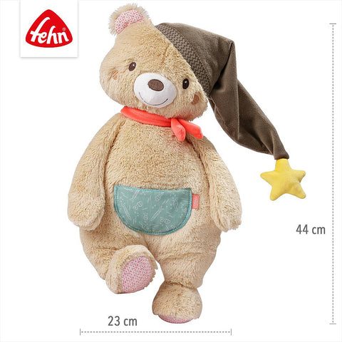 Der XL Kuschelbär trägt eine braune Nachtmütze mit gelbem Stern, einen orangefarbenen Schal und hat eine blaue Tasche. Mit 44 cm Höhe und 23 cm Breite ist er der perfekte Kuschelfreund für gemütliche Momente.