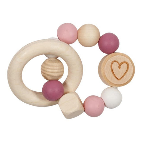 Der Greifling Elastik Herz, rosa ist ein Beißring aus Holz und Silikon mit rosa, weißen und natürlichen Perlen, einschließlich einer Perle mit Herzgravur. Hergestellt in Deutschland aus Silikonperlen und Holz für sichere und stilvolle Beruhigung.